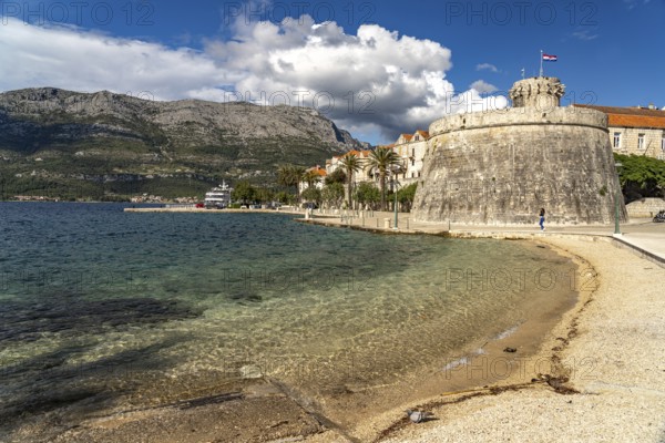 Luka Korculanska beach and the large prince's tower and the old town centre of Korcula, Croatia,