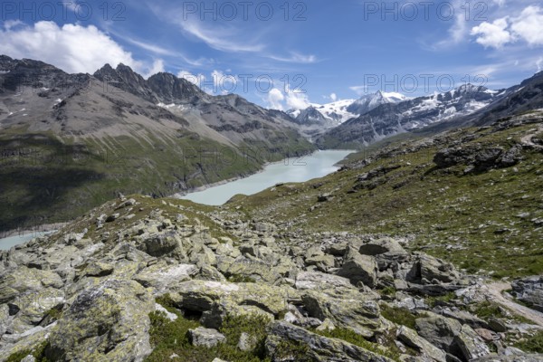 View of idyllic mountain landscape with blue mountain lake, Lac des Dix reservoir, behind mountain