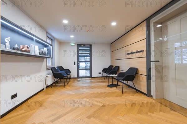 Modern waiting room with seating, wooden wall and decorative shelf, Nagold Town Hall, Black Forest,