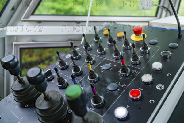 Detail of a control panel with numerous colour-coded levers and buttons, Hermann Hesse Bahn track