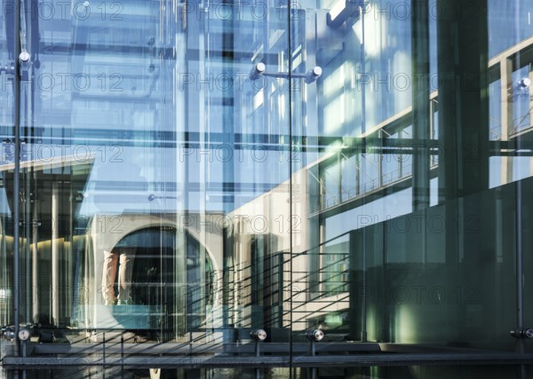 The Marie-Elisabeth Lüders House is reflected in the window of the Paul Löbe House, both parliament