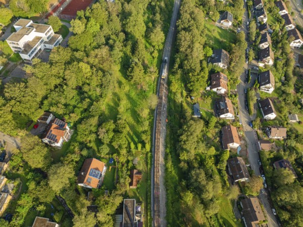 Railway line through green residential areas and landscapes, track construction, rail delivery for