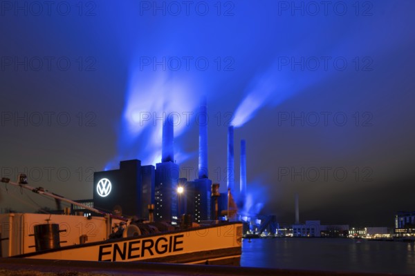 Illuminated cogeneration plant of Volkswagen, Volkswagen logo, the sky above the Mittelland Canal