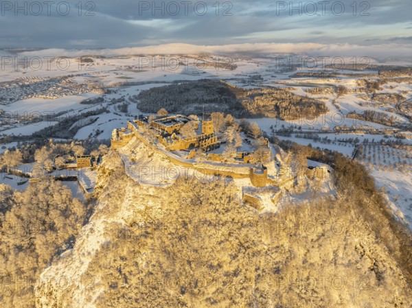 Aerial view of the snow-covered Hegau volcano Hohentwiel with Germany's largest castle ruins on a