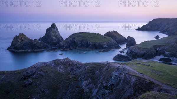 Kynance Cove with Asparagus Island, with sea, sandy beach and rocks in the evening. Coastal