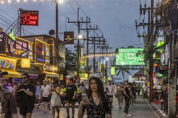 Crowds of people on Bangla Street in the evening. Nightlife on Bangla Walking Street with go-go
