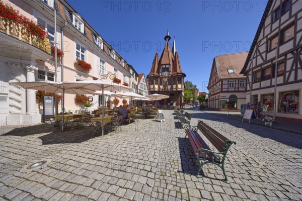 Market square with historic town hall, benches and outdoor area of a café in Michelstadt, Odenwald,