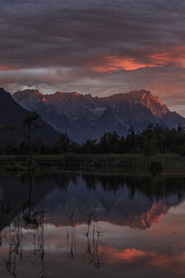 Mountains reflected in lake, sunset, cloudy mood, alpenglow, summer, seven springs, behind
