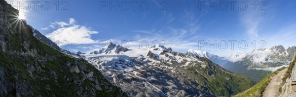 High alpine mountain landscape with sun star, summit of Aiguille de Chardonnet and Glacier du Tour,