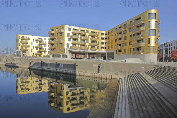 Modern golden building Pandion Doxx and reflection in the harbour, quay, quay wall, staircase,
