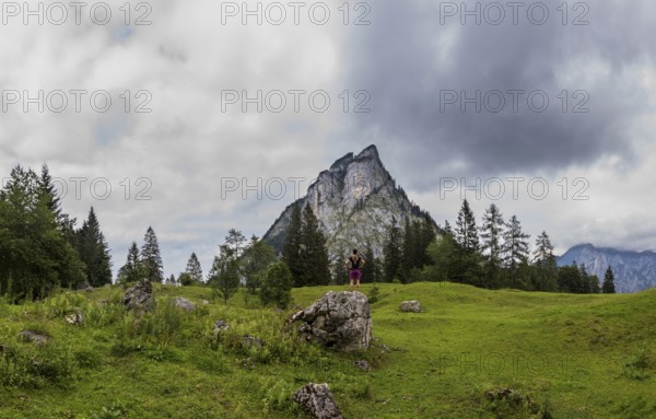 Hiker on the Schartenalm with a view of the Sparber, Osterhorn group, Salzkammergut, Salzburg