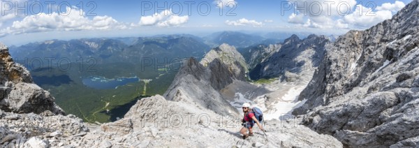 Panorama, mountaineer with helmet in a secured via ferrata, Zugspitze via ferrata, ascent to the