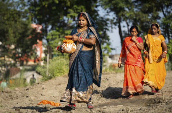 Hindu devotees perform rituals as they offer prayers to the Sun god in the bank of Brahmaputra