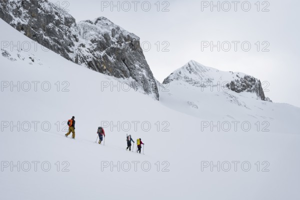 Ski tourers in a snowy mountain landscape, ascent to the Wildhorn, cloudy mood, high tour, Bernese