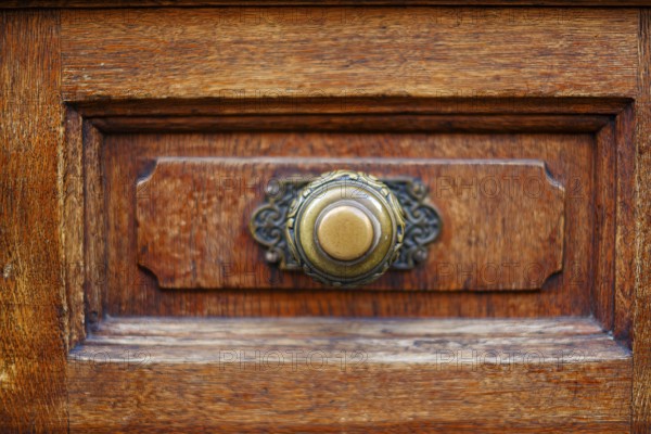 Brass door knob, mounted on the panelled panel of a wooden door, Alter Peter in Munich, Bavaria,