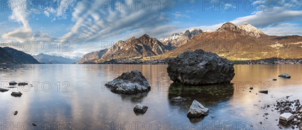 Evening atmosphere at Lago di Como with large boulders in the water, Lombardy, Italy, Europe