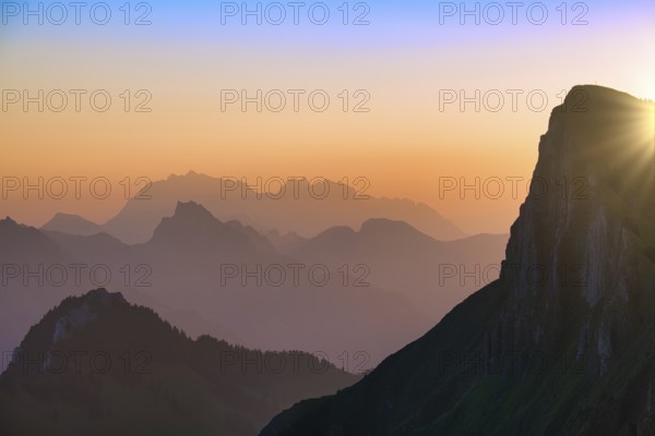 Appenzell Alps with Alpstein and Säntis at sunrise, in the foreground rock face of the Tierberg,