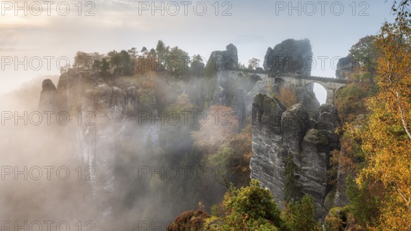View of the Bastei Bridge with morning mist in autumn, Bastei near Rathen, Elbe Sandstone