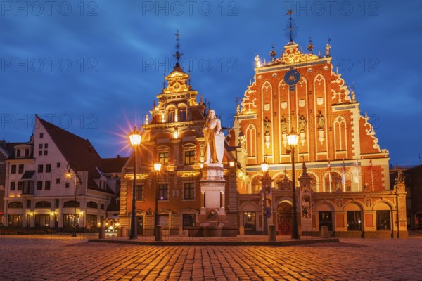 Riga Town Hall Square, House of the Blackheads and St. Roland Statue illuminated in the evening