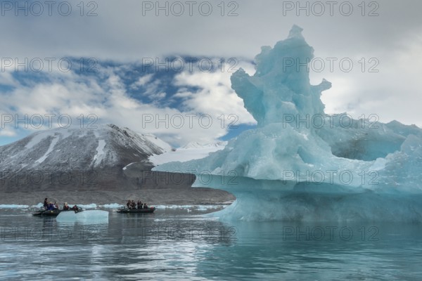 Dinghy with tourists, iceberg, near glacier edge of Monacobreen, Liefdefjord, Woodfjord area,