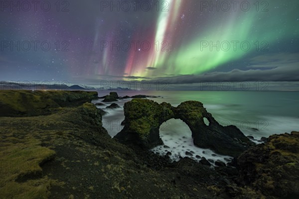 Northern lights over rock structure, coast near Arnarstapi, Snäfellsnes peninsula, Snæfellsnes,