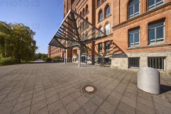New town hall, brick architecture, architectural style neo-Gothic, high round window arches,