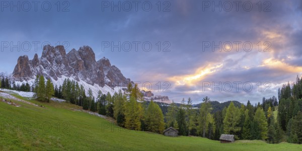 View of a part of the Geisler group in the foreground two alpine huts, sunset, Dolomites, snow,