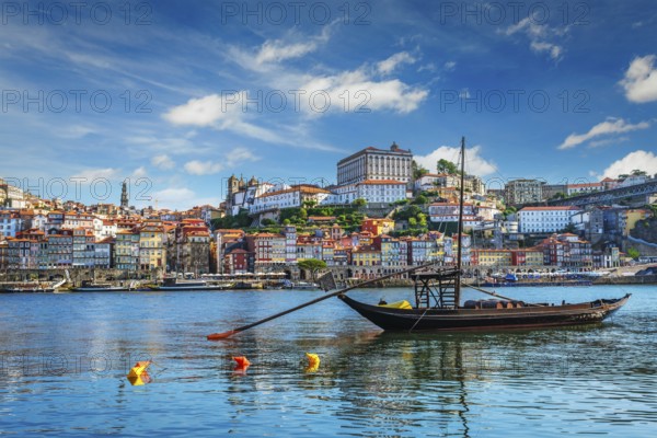 View of Porto city and Douro river with traditional boats with port wine barrels ship from famous