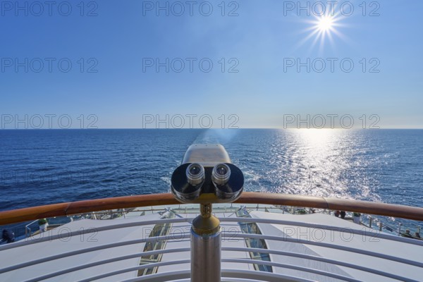 View from the ship's deck, Mein Schiff 6, under bright sunshine and blue sky, binoculars at the