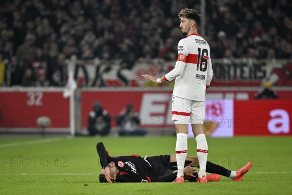 Atakan Karazor VfB Stuttgart (16) with Hugo Ekitike Eintracht Frankfurt SGE (11) injured Injury