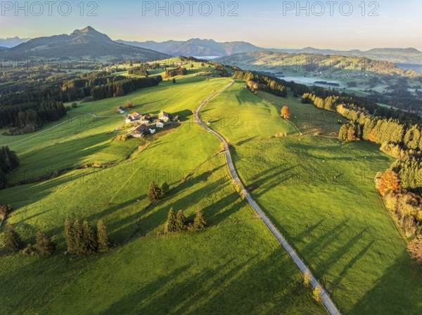Mountain range near village Wertach, view to mt. Gruenten, sunrise, fog in valley, traditional