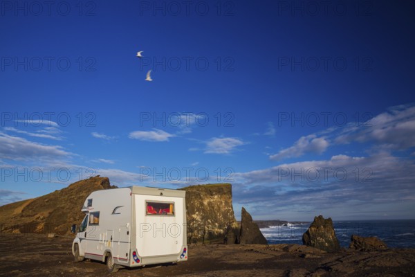 Motorhome parking on the shoreline, south of Sandvik with crashing waves. Rough nature