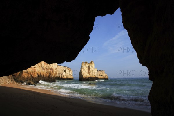 Praia do Pinhao, Lagos, Algarve, Portugal, A view from a grotto to the sea with a sandy beach and