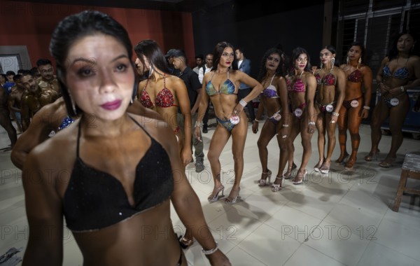 Female bodybuilders wait backstage to compete the 4th Ms Saraighat all India classic body building