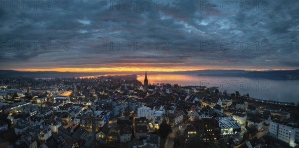 Aerial view, panorama of an atmospheric sunrise over the town of Radolfzell on Lake Constance with
