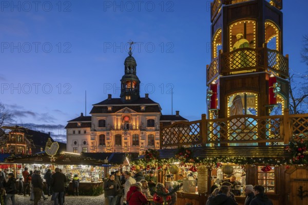 Christmas market with large Christmas pyramid on the market square, behind the historic town hall,
