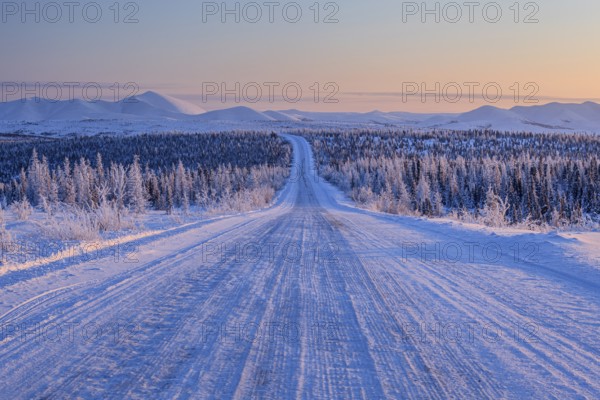 Snow-covered gravel road, highway, ice, snow, cold, mountain landscape, winter, morning mood,