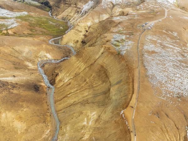 Steaming hot springs and colourful rhyolite mountains, parking lot, aerial view, Hveradalir