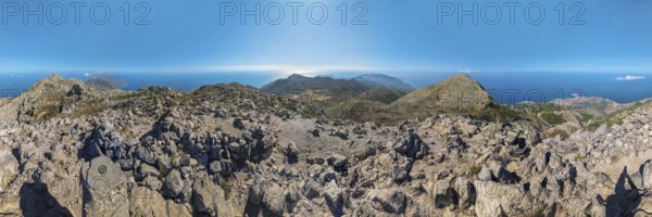 360° summit view from Kali Limni of mountains and the ocean under a blue sky, hike to the summit of