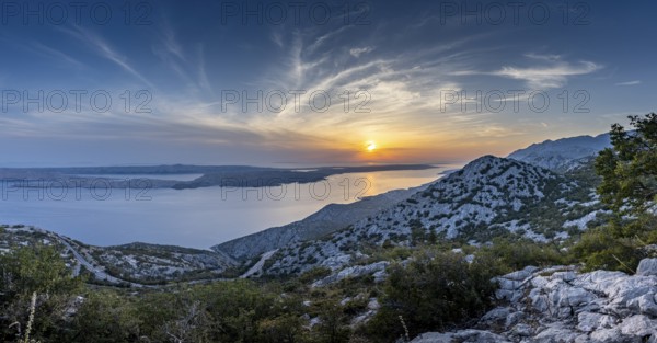 Majestic mountain landscape with sea at sunset and evening sky, pass road, Pag, Zadar, Croatia,