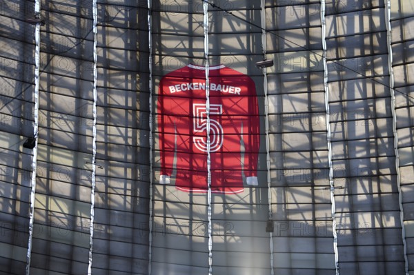 Larger-than-life jersey of Franz Beckenbauer with shirt number 5 hanging in the grandstand roof of