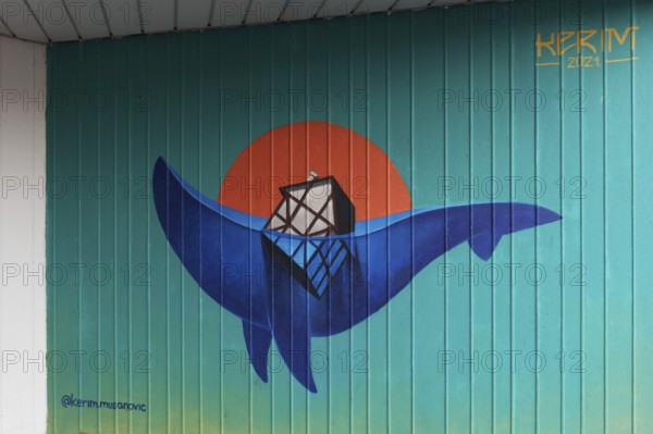 House sinks into an ocean wave in the shape of a whale, symbolic mural on the subject of climate