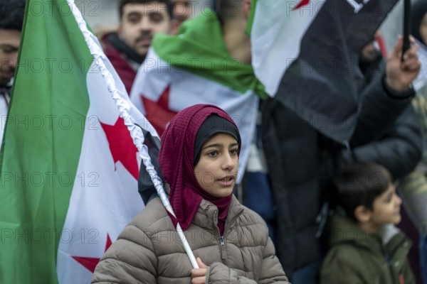Syrian woman celebrate the end of the Assad regime after the change of power in Syria at a rally on