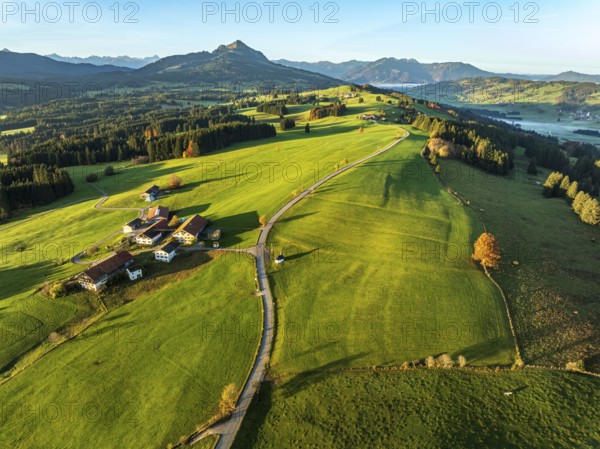 Mountain range near village Wertach, view to mt. Gruenten, sunrise, fog in valley, traditional
