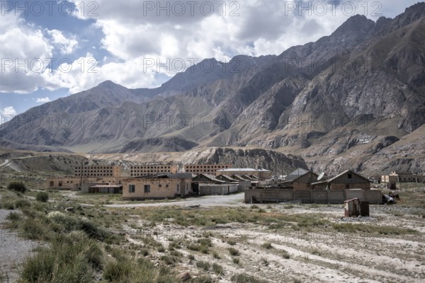 Abandoned ruined buildings in a mountain landscape, ghost town, Engilchek, Tian Shan, Kyrgyzstan,