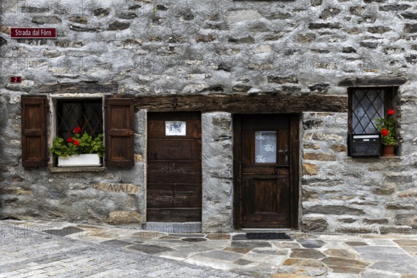 Entrance door and window of a typical Ticino stone house in the village of Sonogno, Verzasca