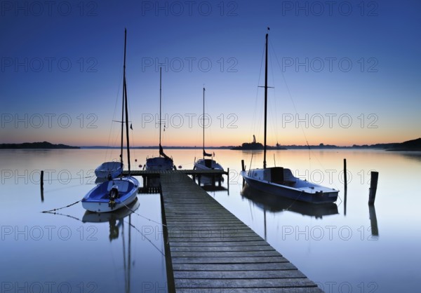 Dawn on the Schaalsee, wooden jetty with sailing boats, Schaalsee Biosphere Reserve,