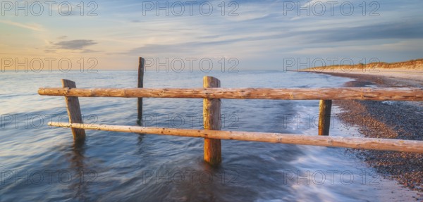 Fence on the beach of the Baltic Sea as the border of the cordoned-off core zone of the Western