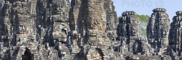 Panoramic image of giant stone-carved faces of the Bodhisattva Lokeshvara, also known as