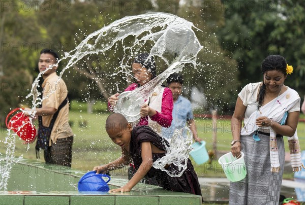 NAMSAI, INDIA.- APRIL 16: Devotees celebrate the vibrant Sangken Festival by pouring water over